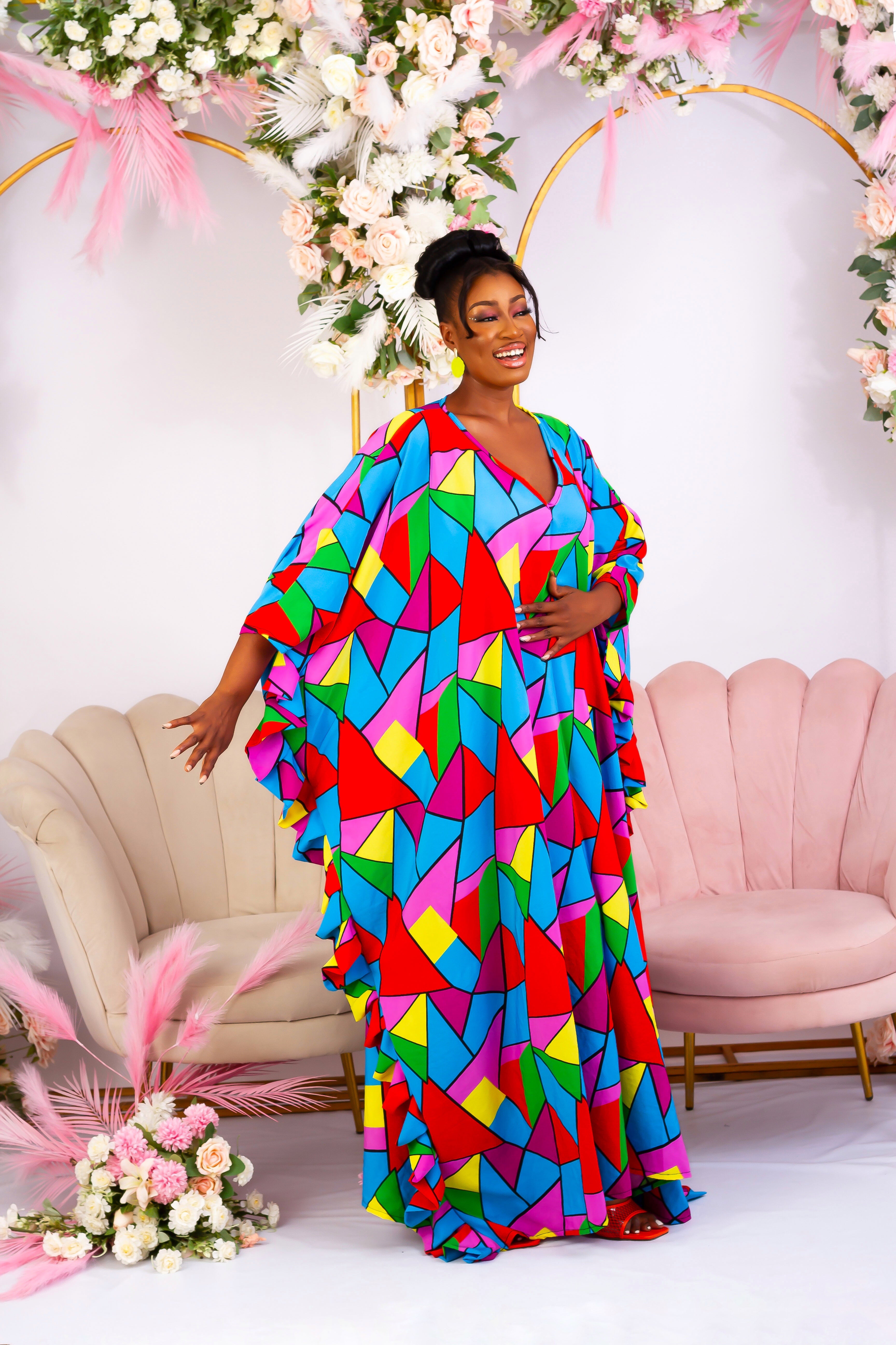 Side view of our African print crepe boubou kaftan. Shop African inspired clothing, African boubou, bubu, Maxi Kaftan, African crepe gown, this long bubu kaftan for women is handmade with multicoloured crepe fabric. V neckline with frill sleeves.