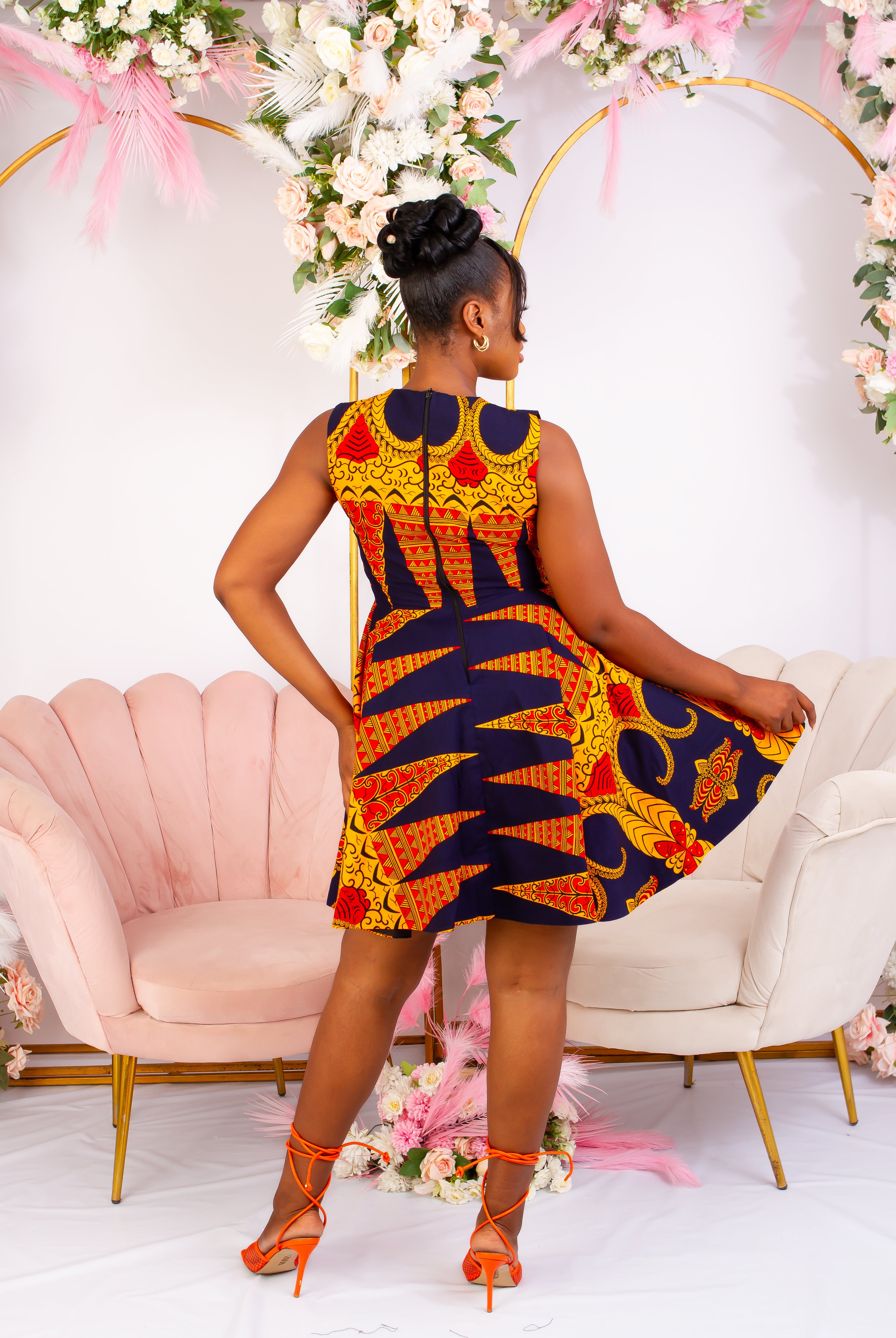 Vibrant Yellow and Navy Blue African Print flare mini dress perfect for a special occasion. Sleeveless with bust cut out for an edgy and chic look. Shop Ghana African print dress | African short dresses | African print gown | African Clothing Online Shop | Maxi African dress | African women's clothing | kitenge dresses | Africa Dresses for Women | African dresses for wedding | Danshiki Dress | Trendy African Dress | African clothing UK