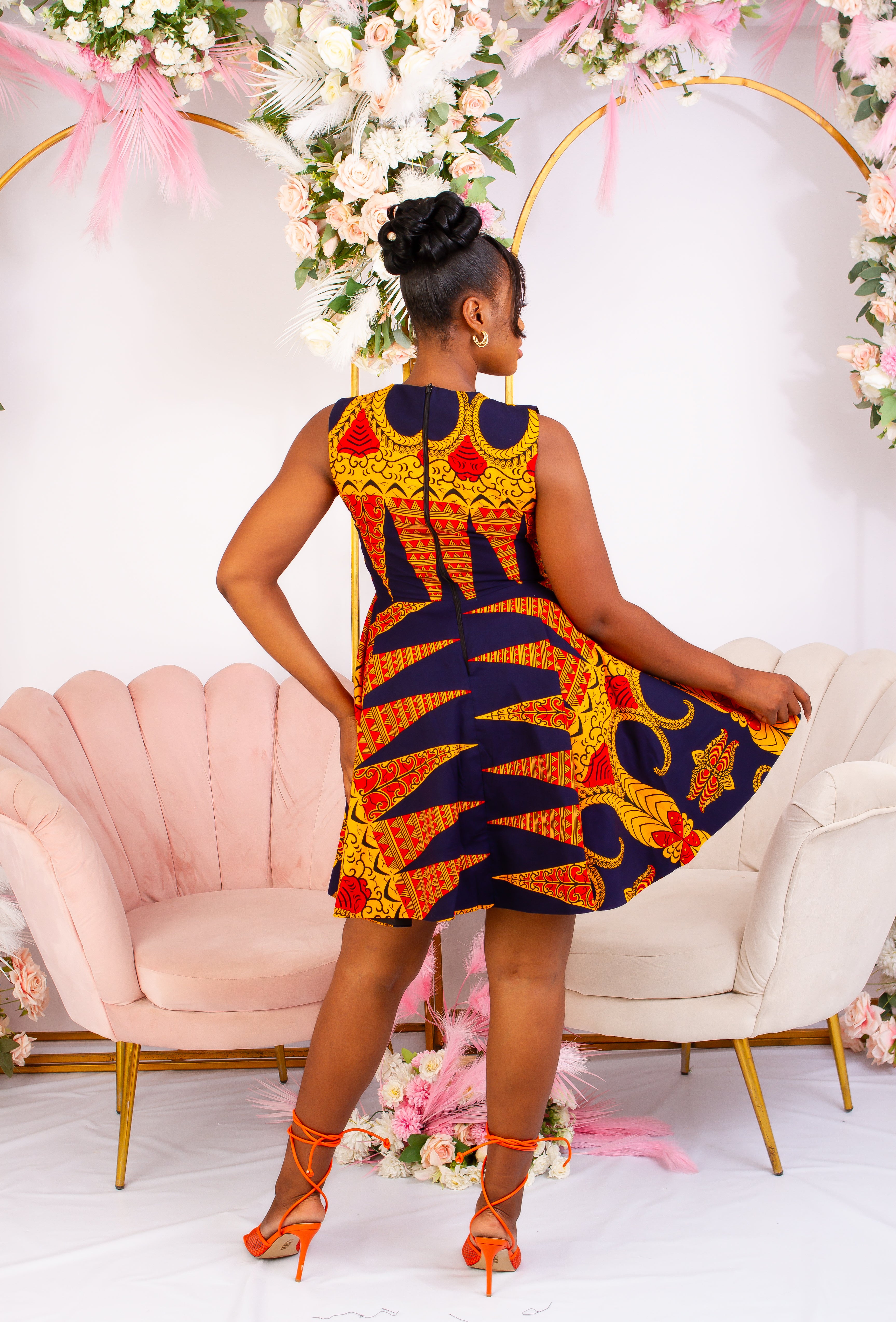 Vibrant Yellow and Navy Blue African Print flare mini dress perfect for a special occasion. Sleeveless with bust cut out for an edgy and chic look. Shop Ghana African print dress | African short dresses | African print gown | African Clothing Online Shop | Maxi African dress | African women's clothing | kitenge dresses | Africa Dresses for Women | African dresses for wedding | Danshiki Dress | Trendy African Dress | African clothing UK