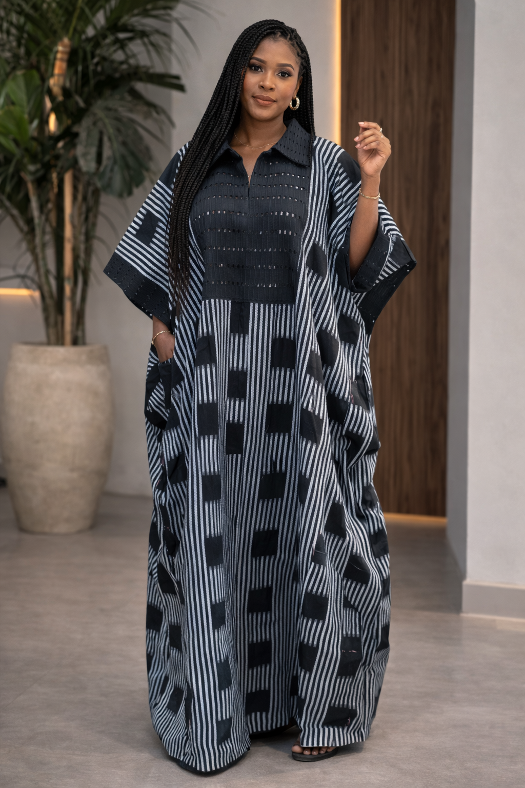 Woman wearing a black and white patterned dress in an indoor setting
