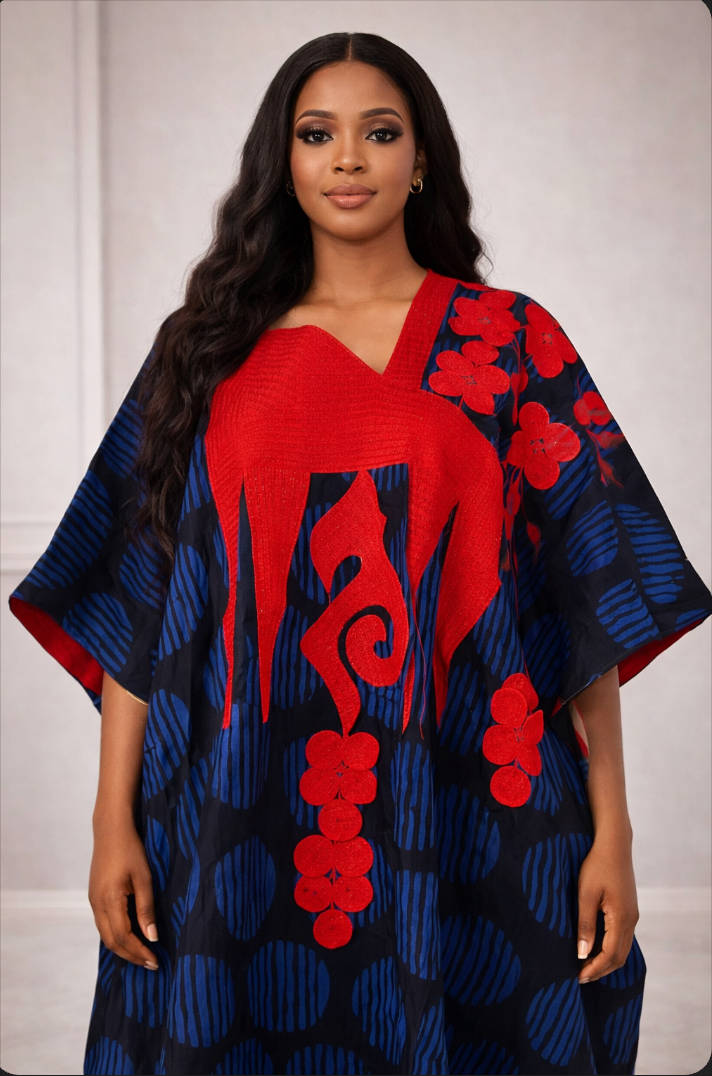 Woman wearing a vibrant red and blue patterned dress against a plain background