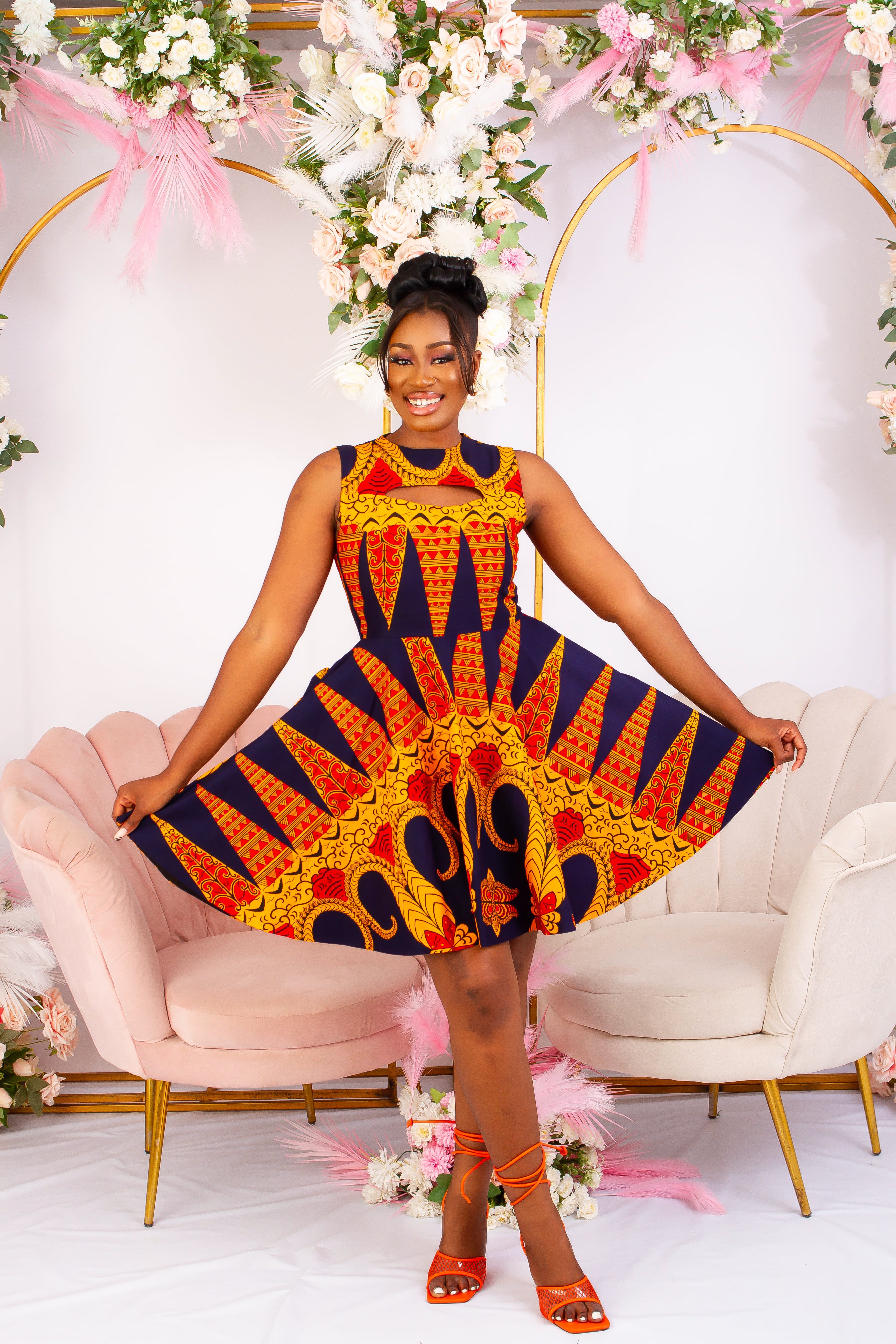 Vibrant Yellow and Navy Blue African Print flare mini dress perfect for a special occasion. Sleeveless with bust cut out for an edgy and chic look. Shop Ghana African print dress | African short dresses | African print gown | African Clothing Online Shop | Maxi African dress | African women's clothing | kitenge dresses | Africa Dresses for Women | African dresses for wedding | Danshiki Dress | Trendy African Dress | African clothing UK